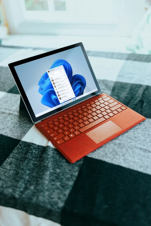 this is an orange surface computer on top of a black and white table