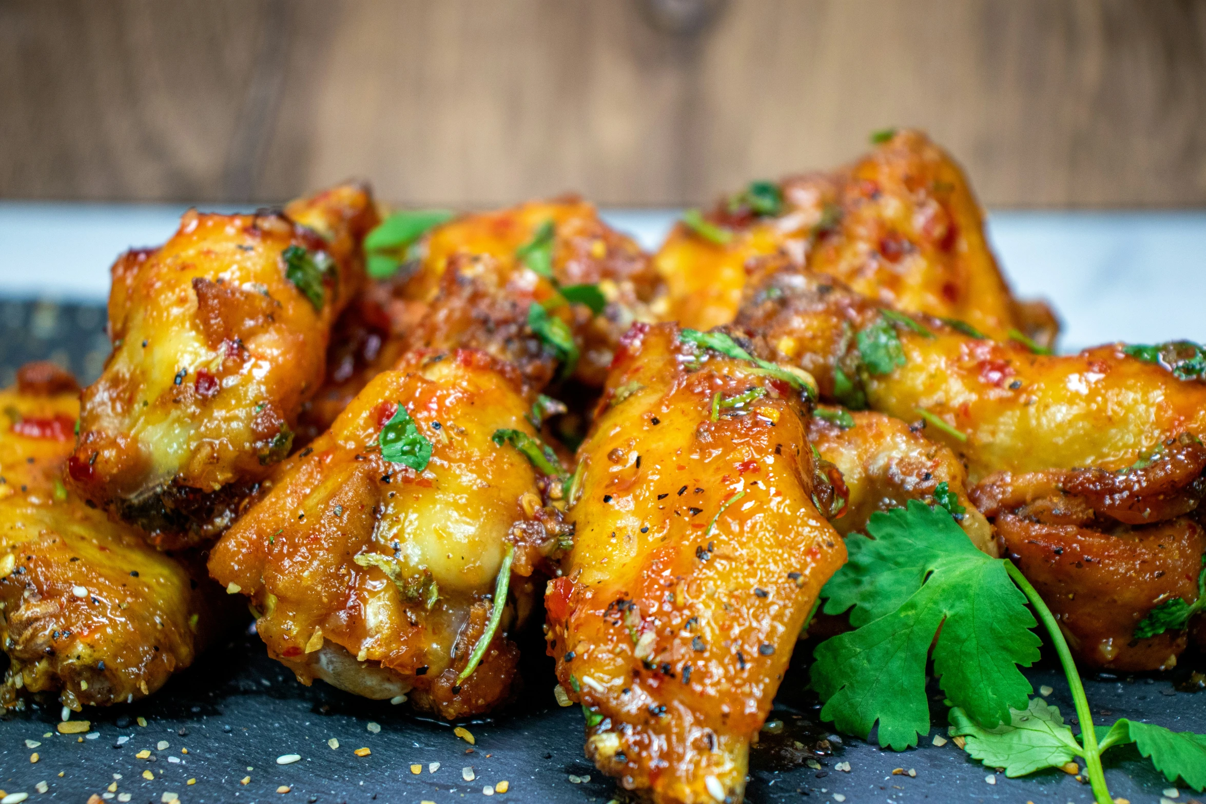 a close - up s of some chicken wings with sauce