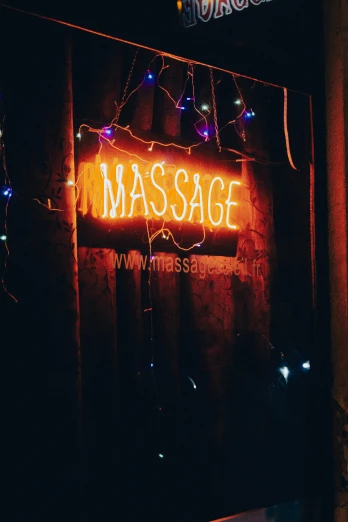 a lighted massage sign above a doorway