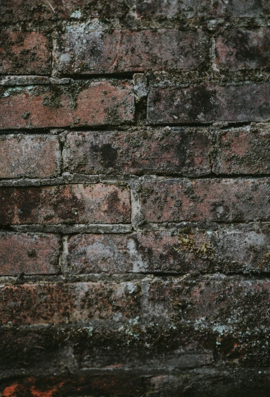 a cell phone is shown in front of a brick wall
