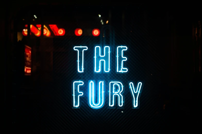 a glowing neon sign in the dark that says the fury