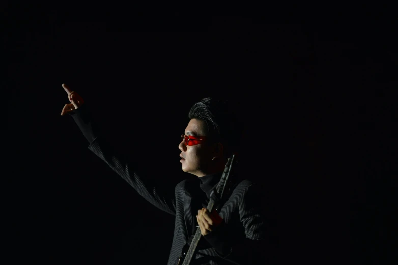 a female with glasses and holding a black umbrella