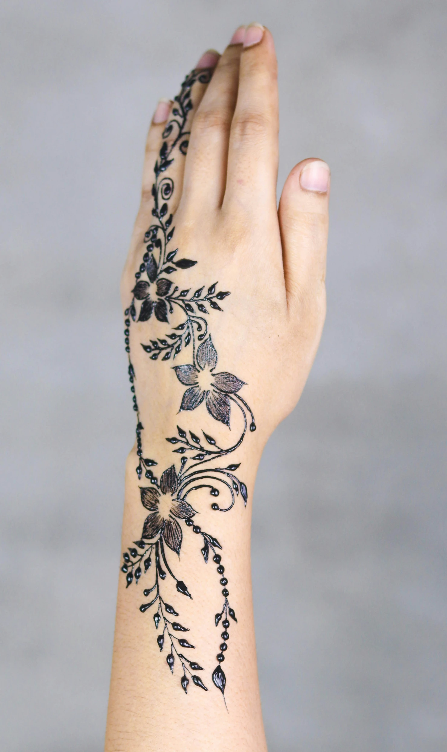 the arm and hand with an elaborate tattoo on it