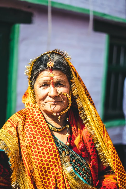 a women dressed in colorful attire standing outside