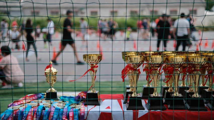 a table topped with trophies sitting on top of a table