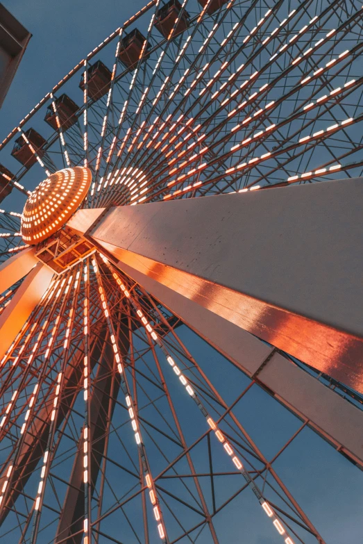 a large ferris wheel with a building in the background