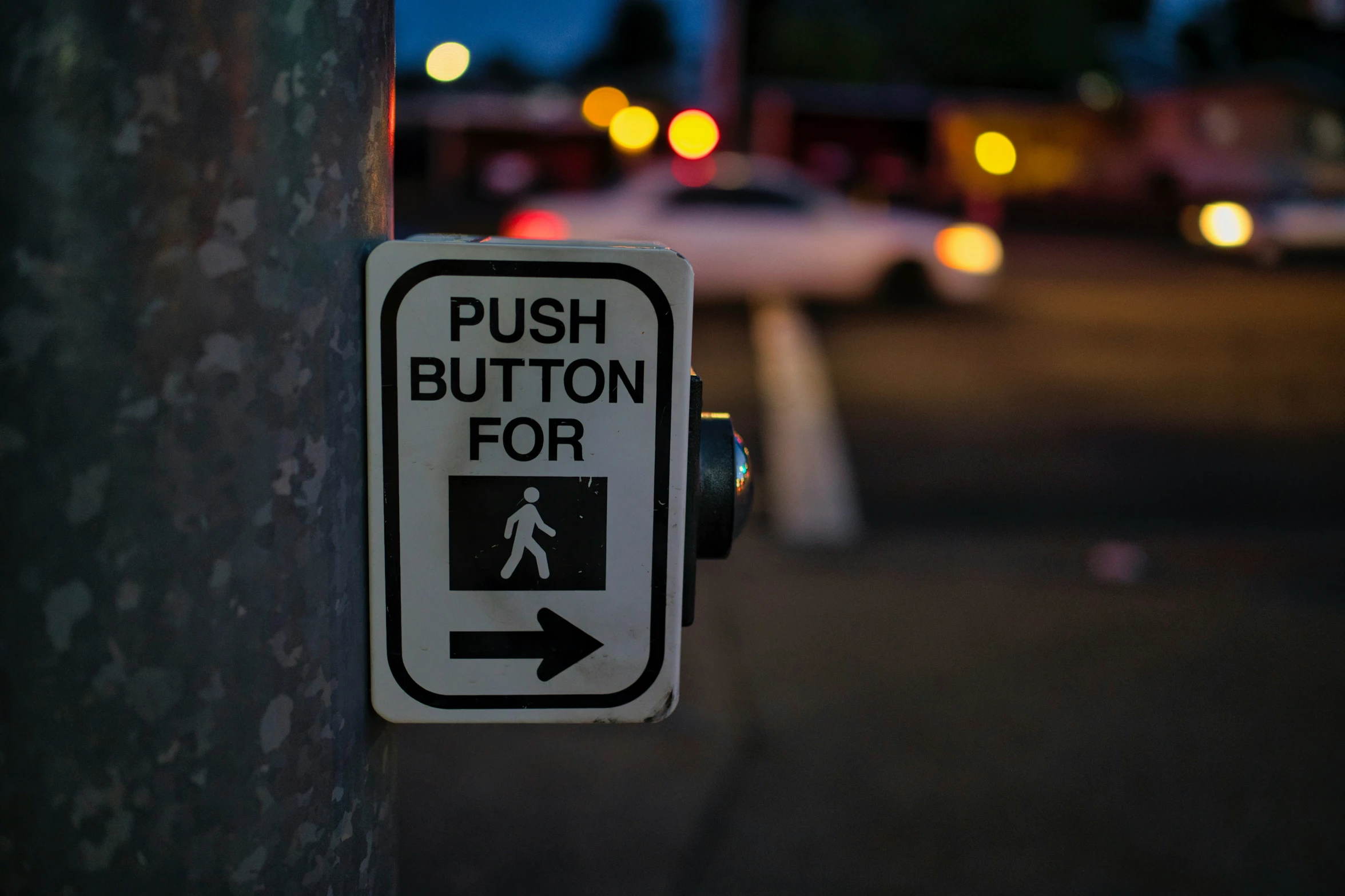 the street sign is hanging on the pole