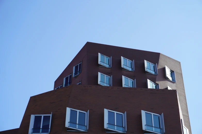 an unusual looking building with windows on the roof