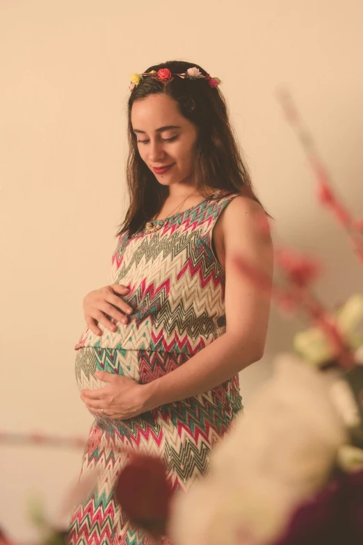 a beautiful young woman in a dress is standing