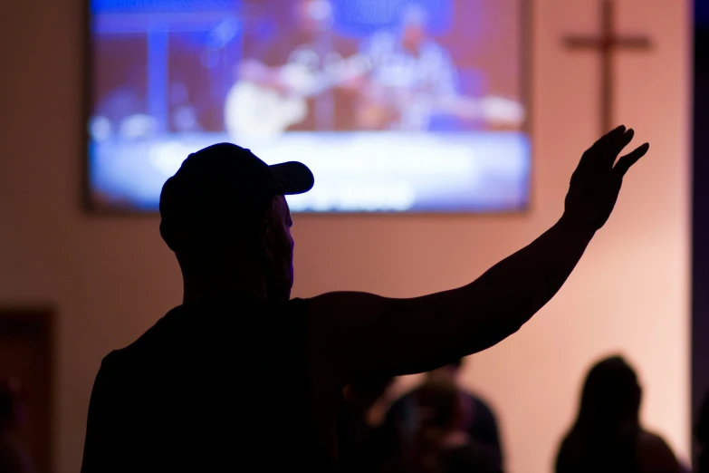 a man holding his arms out with his hands open