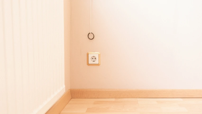 a small white room with an open door and a wall mounted device