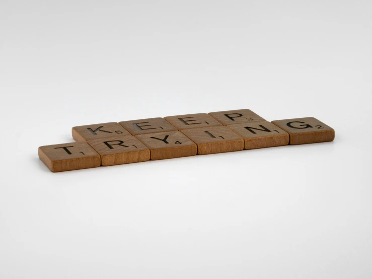 a scrabble font with small words on top