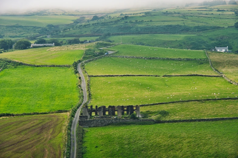 a picture taken from a very long distance of green fields and countryside