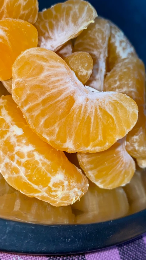 peeled orange slices in a glass bowl