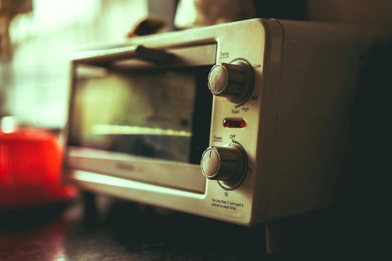 a silver microwave on top of a wooden counter