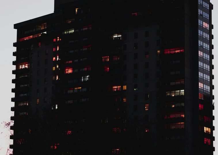 the top of a tall building with windows lit up