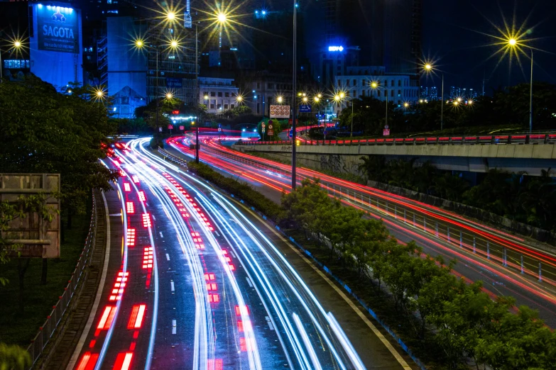 some cars drive on a road at night time