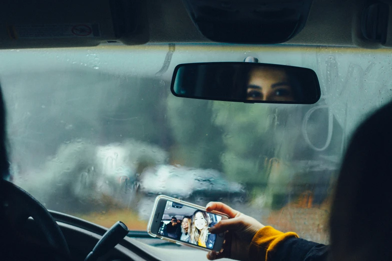 a man is taking his po with a cellphone