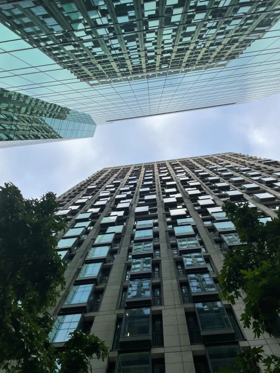 the sky is reflected in windows on a tall building