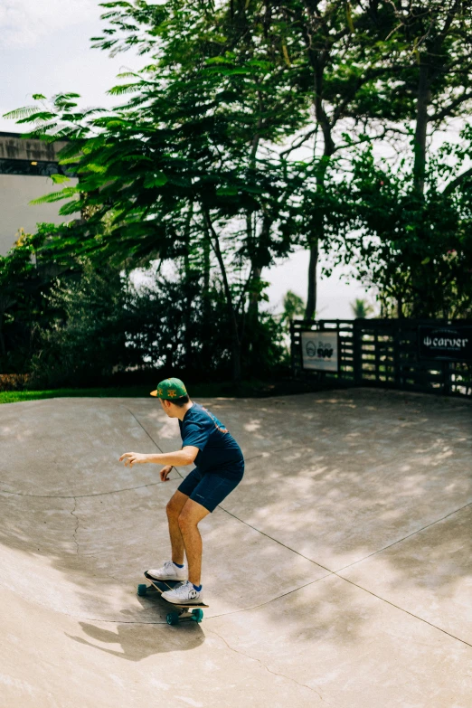 a young man wearing blue is doing skateboard tricks