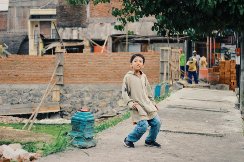 a boy that is walking down a road