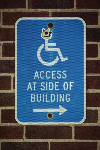 a blue handicapped accessible sign with white lettering