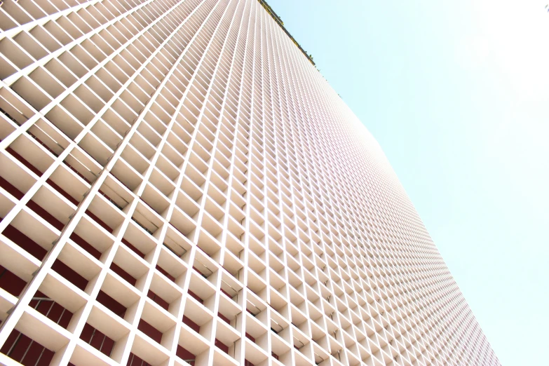 the side of a large building with lots of grids on the front