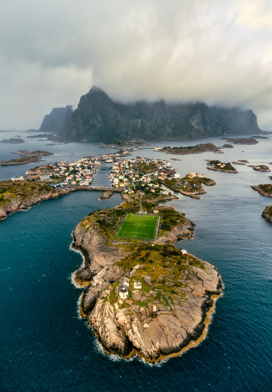 a large lake sits between some mountains with a few houses