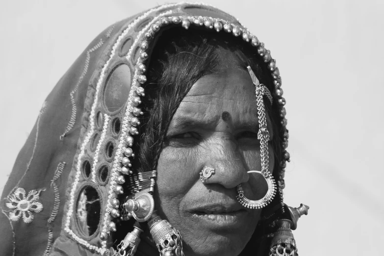 a woman is posing with a nose ring