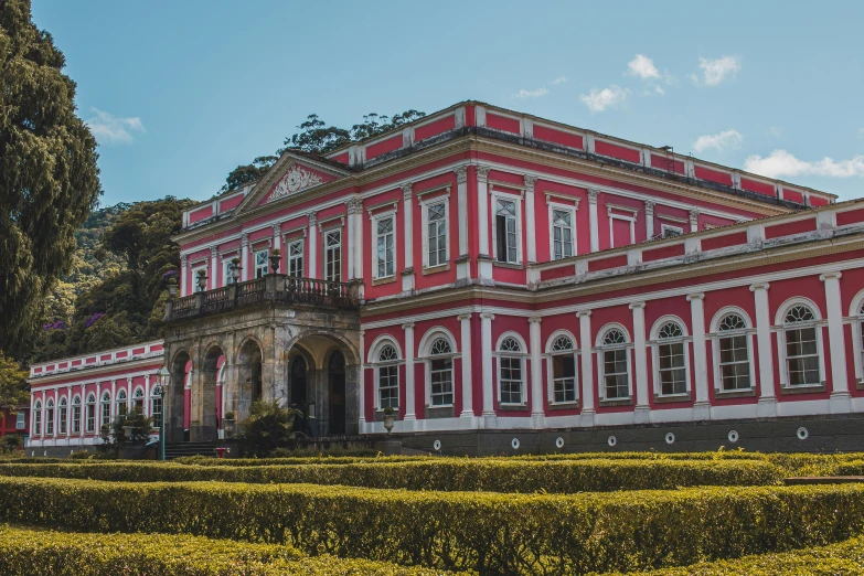 the large building has lots of windows and a large garden area next to it