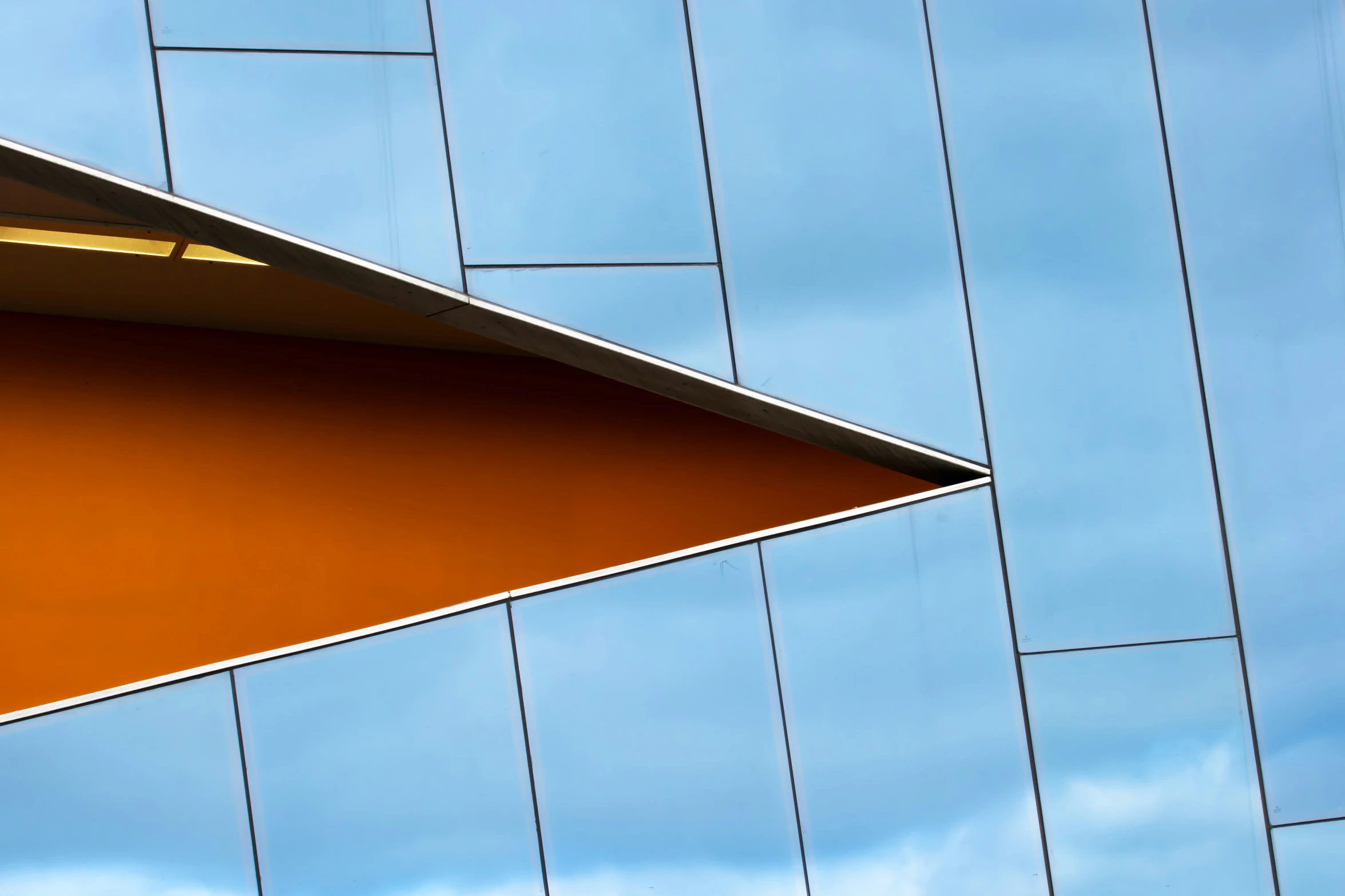 an orange curved roof of a building that is metal