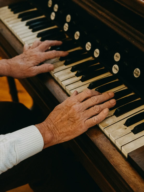 a man holding a white and black organ with both hands