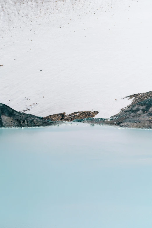 a mountain range with a pool of water in the foreground