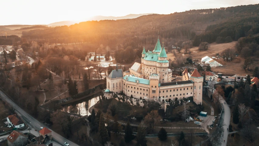 an aerial po of a castle surrounded by hills