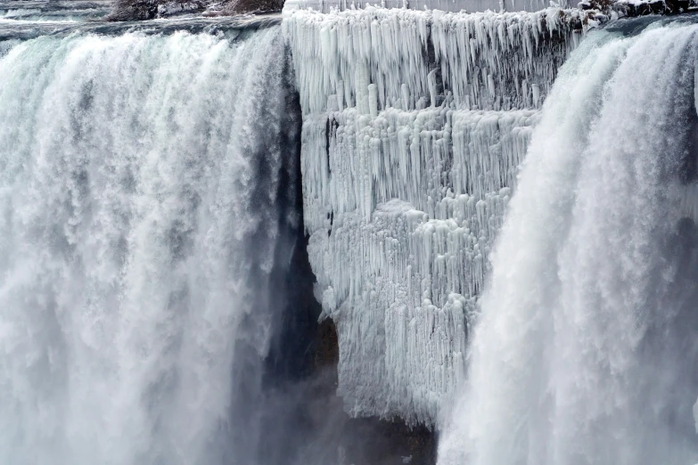 a waterfall with icicles on it that is melting