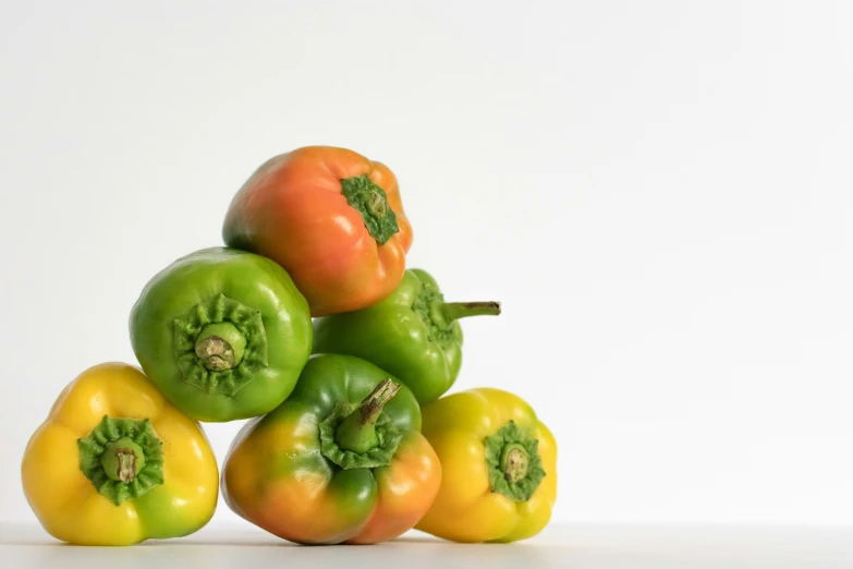 a stack of bell peppers sitting on top of each other