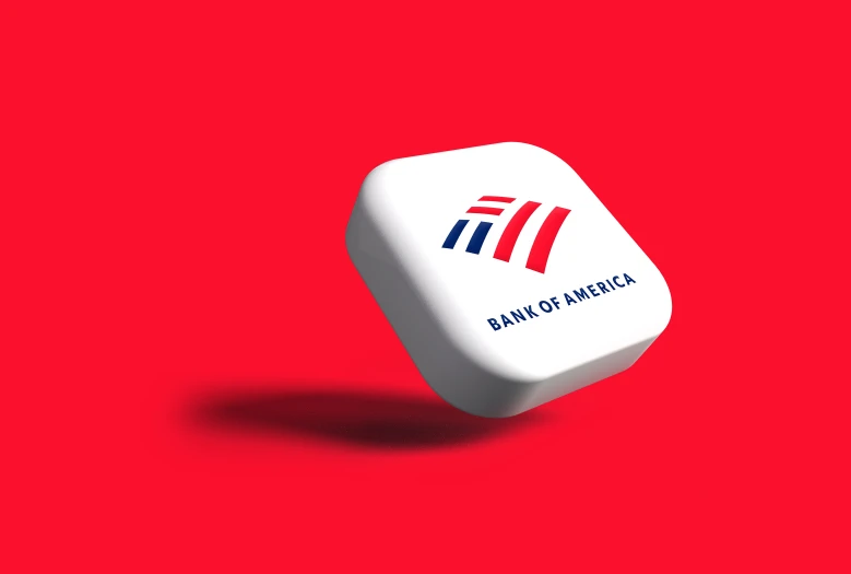 a bank of america dice sitting on top of a red surface
