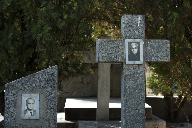 a small cross statue in the middle of the ground