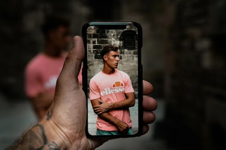a person holding up a cell phone with the image on it