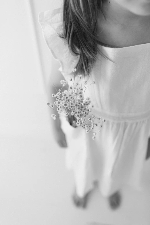 a woman is standing near a glass in the room