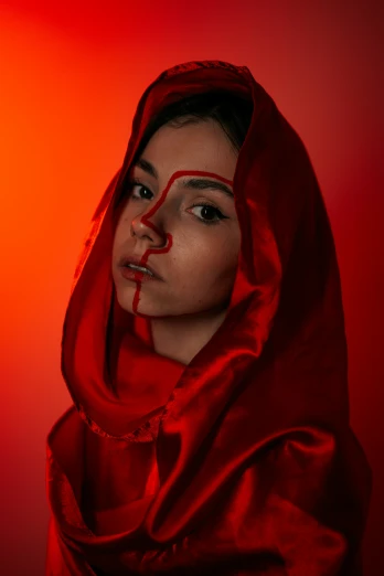 a woman in red wearing a veil and nose art