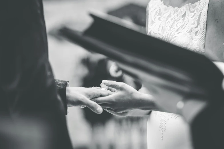 a close up view of two people holding hands