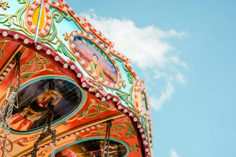 colorful, brightly decorated carousel rides with blue sky background