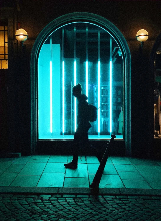 a man carrying a suitcase and standing on a tile floor