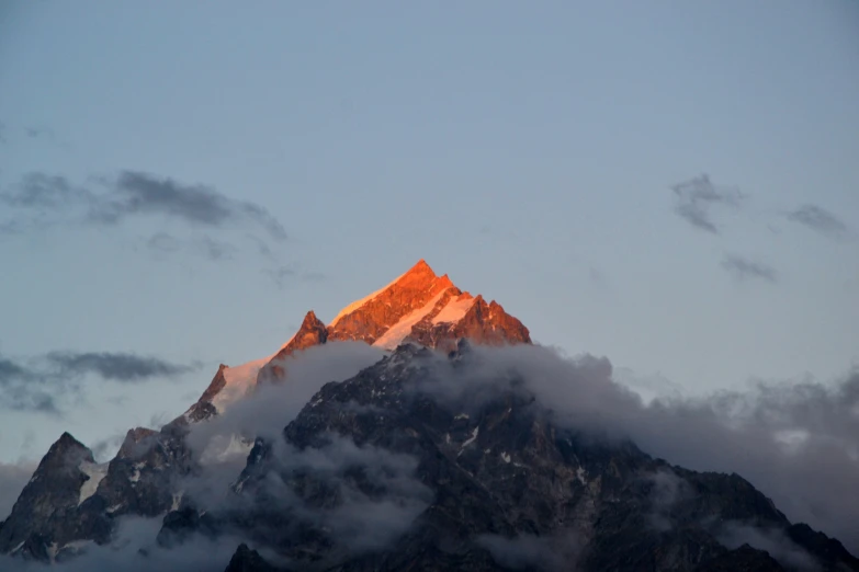 clouds and mountain tops are seen in this scenic po