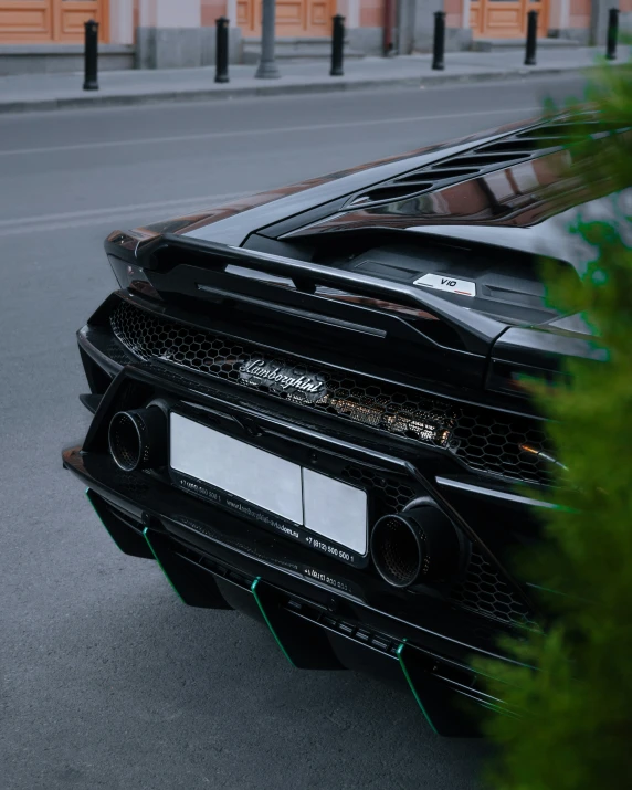 a black car with an exhaust ventilator parked in a lot