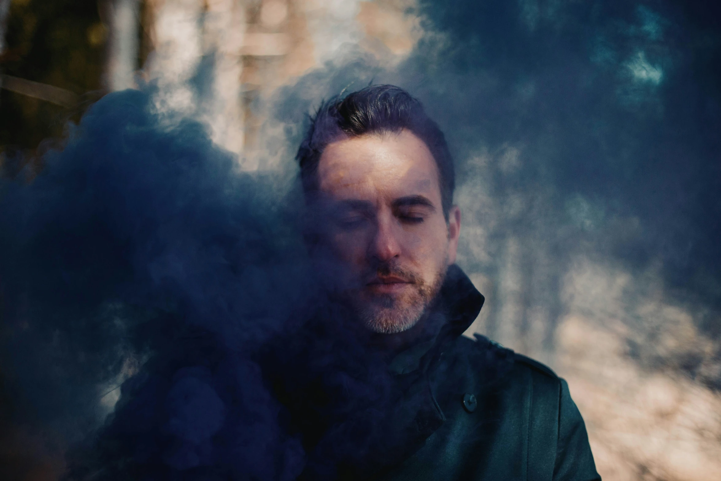 the man is smoking a cigarette near a building