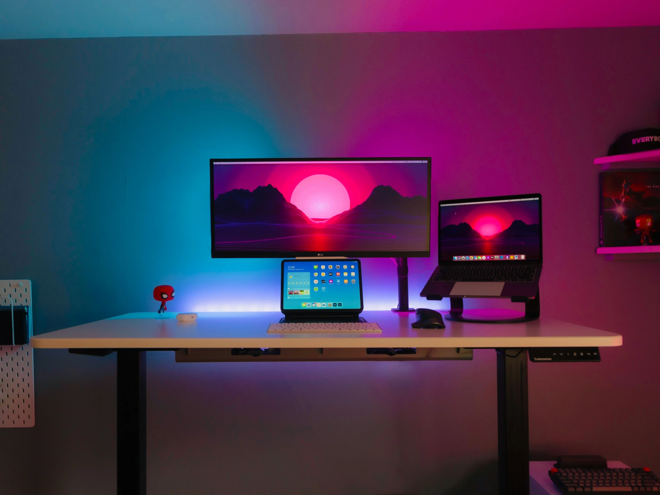 a desk that has two computer monitors and a laptop