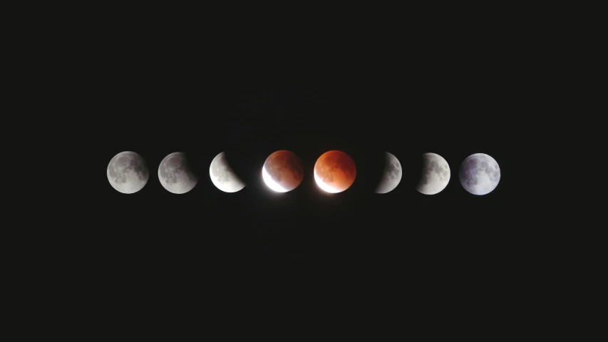 a row of five eclipses are shown with black background