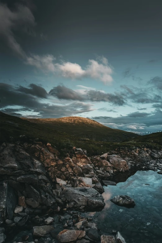 rocky stream and landscape at dusk with sky